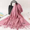 Solid soft pink faux cashmere scarf with tassels draped over a black leather handbag - 200*70cm / Leather Red