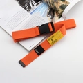 Detail of orange nylon tactical belt with black plastic buckle and star patch detail - Orange