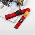 Detail of red nylon canvas belt with black plastic buckle and star motif textile label - Red
