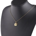 Close-up of golden zodiac necklace with clear birthstone on a black neck bust - 4-4 Cancer
