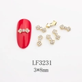 Macro shot of 3x8mm gold alloy bowknot nail charm with pearls and rhinestones - Gold Base White Rhinestone (LF3231) / 3*8mm