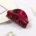 Macro shot of dark red marble textured acetate hair claw clip on white table - Wine Red Starry Marble