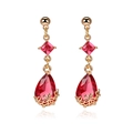 Detail view of 18K gold teardrop earrings featuring faceted red crystal and floral filigree - Red