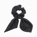 Detail of a black fabric scrunchie with bunny ear bow design on white background - Black