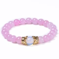 Pink quartz bead bracelet featuring golden crown charms and central opal bead - Rose Quartz