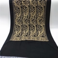 Close-up of golden paisley embroidery and fringe on black cashmere-style scarf - Black