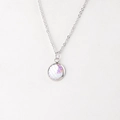 Detailed macro view of 12mm round mermaid scale pendant on a silver stainless steel chain - White Rainbow Iridescent (15)