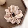 Champagne satin silk scrunchie with streamer on a wooden tray background - Champagne