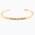 Golden stainless steel mantra bracelet with 'NO RAIN, NO FLOWERS' engraved quote - NO RAIN NO FLOWERS