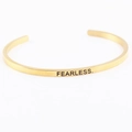 Adjustable golden stainless steel cuff bracelet with FEARLESS engraving on it - FEARLESS.
