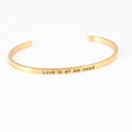 Minimalist gold stainless steel open mantra bracelet with Love Is All We Need engraving - LOVE IS ALL WE NEED