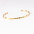 Golden titanium steel C-shaped cuff bracelet with SOUL SISTERS engraving - SOUL SISTERS