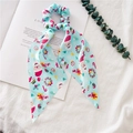 Detailed view of light blue Christmas scrunchie with long ribbon on a book page - Light Blue Snowman