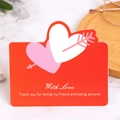 Red paper card with hollow heart pattern and With Love text on marble surface - Heart with Arrow