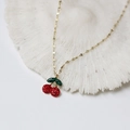 Detailed view of cherry pendant necklace with red crystals on a white coral base - Stainless Steel/Rhinestone / Cherry Necklace