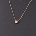 Vista de cerca del colgante de flor en oro rosa pulido con una cadena de eslabones - Oro rosa