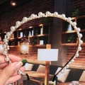 Close-up of pearl headband with woven gold wire detail and protective black end caps - 2# Twisted Mixed Size Pearls