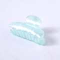 Detail view of a light blue pearlescent hair claw clip with acetate finish and smooth teeth - Aqua Blue Water Ripple Square Head