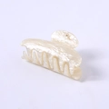 Close-up of pearl white shark hair claw clip with elegant marble texture and smooth finish - Champagne Water Ripple Square Head