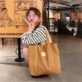 Canvas tote bag in coffee brown shown with white square label and large capacity style - Apricot Yellow