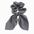Detailed close-up of dark grey satin scrunchie with long bow ribbon ties on white background - Dark Gray