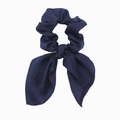 Detailed view of deep blue satin scrunchie with long ribbons and smooth texture - Navy Blue