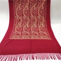 Detail view of golden paisley embroidery and tassel fringe on a red cashmere scarf - Burgundy