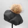 Detail of dark grey knit wool beret featuring a large fluffy brown fur pompom on top - M (56-58cm) / Dark Gray