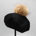 Detail of black knitted wool beret featuring a large fluffy light brown fur pompom top - M (56-58cm) / Black