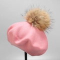 Detail of pink knitted wool beret featuring a large real fur pompom on metal stand - M (56-58cm) / Pink