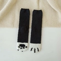 Detailed view of thick coral fleece winter socks featuring a cute black and white cat paw design - One Size / Solid Black
