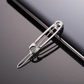 Macro view of a silver metal safety pin hair clip with a sleek reflective surface - Silver Safety Pin Shape Hairclip