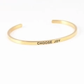 Golden stainless steel C-shaped open bracelet with engraved Choose Joy mantra text - CHOOSE JOY