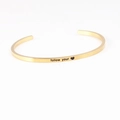 Polished gold stainless steel C-shaped open bracelet with engraved Follow Your mantra - follow your heart
