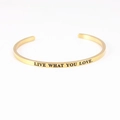 Gold stainless steel C-shaped cuff bracelet engraved with Live What You Love mantra - LIVE WHAT YOU LOVE