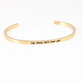 Gold stainless steel cuff bracelet with my story isn't over yet mantra engraving - my story isn't over yet