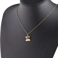 Detail of gold constellation necklace with H-shaped pendant and inlaid blue birthstone - 3-3 Gemini