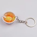 Miniature blue and white porcelain bowl keychain featuring yellow fruit salad and spoon - Style 3 Orange Pineapple Soup