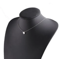 Silver puzzle piece pendant necklace on black display stand, polished stainless steel - Steel