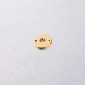Macro view of a gold-plated stainless steel circular charm featuring a crown cutout design - Crown Gold