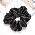Close-up of black satin scrunchie showing smooth silk texture and elegant glossy finish - Black