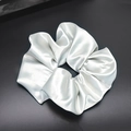 Detailed close-up of shiny silver satin scrunchie with smooth silk-like texture - Light Gray