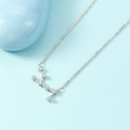 Minimalist silver constellation necklace with shimmering crystals on a light blue background - Virgo