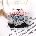 Detail view of 4-pack satin scrunchies in candy colors on a Sweet Girl display card - Satin Pink Blue Grey Black 4-Pack