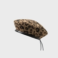Classic leopard print beret featuring black faux leather piping and adjustable drawstring - M / Coffee