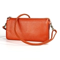 Close-up of bright orange litchi grain leather shoulder bag with golden zipper hardware - Orange