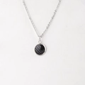 Macro view of mirror-polished stainless steel round pendant with black fish scale texture - Black Scale (14)