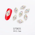 Macro detail of red rhombus nail crystals with alloy base and sparkling rhinestones - Gold Base Marquise Aurora AB (LF3631)
