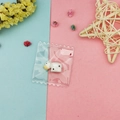 DIY resin cow pendant in clear packaging on pink and blue decorative background - Black and White Cow