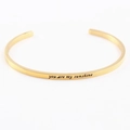 Detailed macro view of the 'you are my sunshine' engraving on a gold stainless steel bangle - You are my Sunshine
